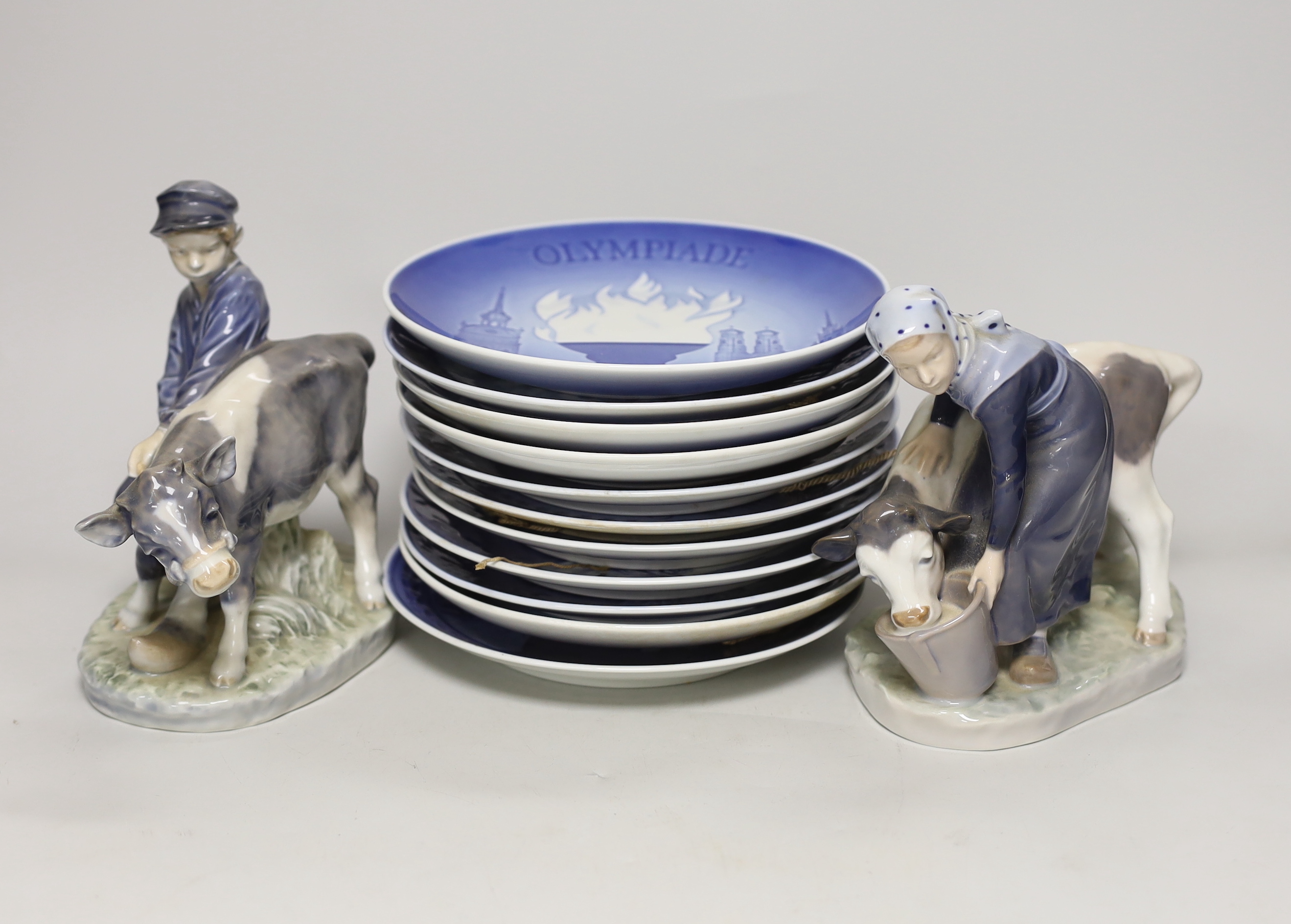 A pair of Royal Copenhagen porcelain figures and assorted commemorative plates, tallest figure 17cm high